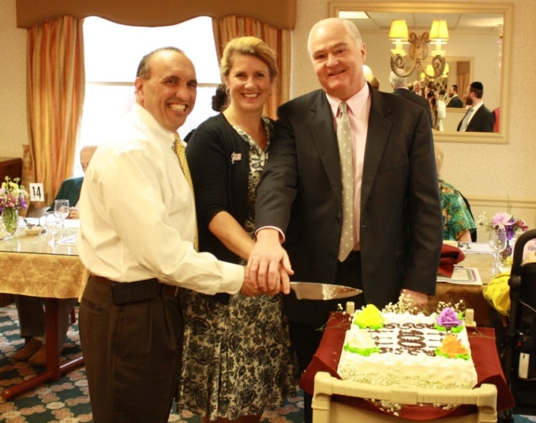 Monmouth County Freeholders Thomas A. Arnone, Serena DiMaso and John P. Curley cut the cake at the Centenarian Birthday Party on May 7, 2014 in Hazlet, NJ.